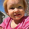 Nora is registered to the contest to win money with this photo: toddler, child, red_hair, outdoor, sunlight, pink_shirt, polka_dot, face, portrait, expression, skin, hands, tree, blue_sky, daylight, casual_clothing, nature, young_child, cute, person