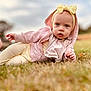 baby, blurred_background, candid, casual_clothing, child, curious, cute, fall, grass, headband, hoodie, infant, nature, outdoor, pastel_colors, portrait, sky, soft_light, yellow_bow, young_child