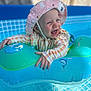 baby, blue, child, clothing, dolphin, floatie, happy, hat, infant, outdoor, pink_hat, playful, pool, sleeves, smiling, summer, sunhat, swimming_pool, toy, water
