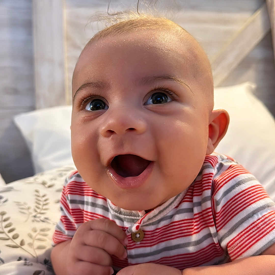 Azriel is registered to the contest to win money with this photo: baby, babylaughing, bed, bedroom, bodypart, couch, face, finger, furniture, hand, happy, head, laughing, mouth, person, photography, portrait, sitting, smile, teeth
