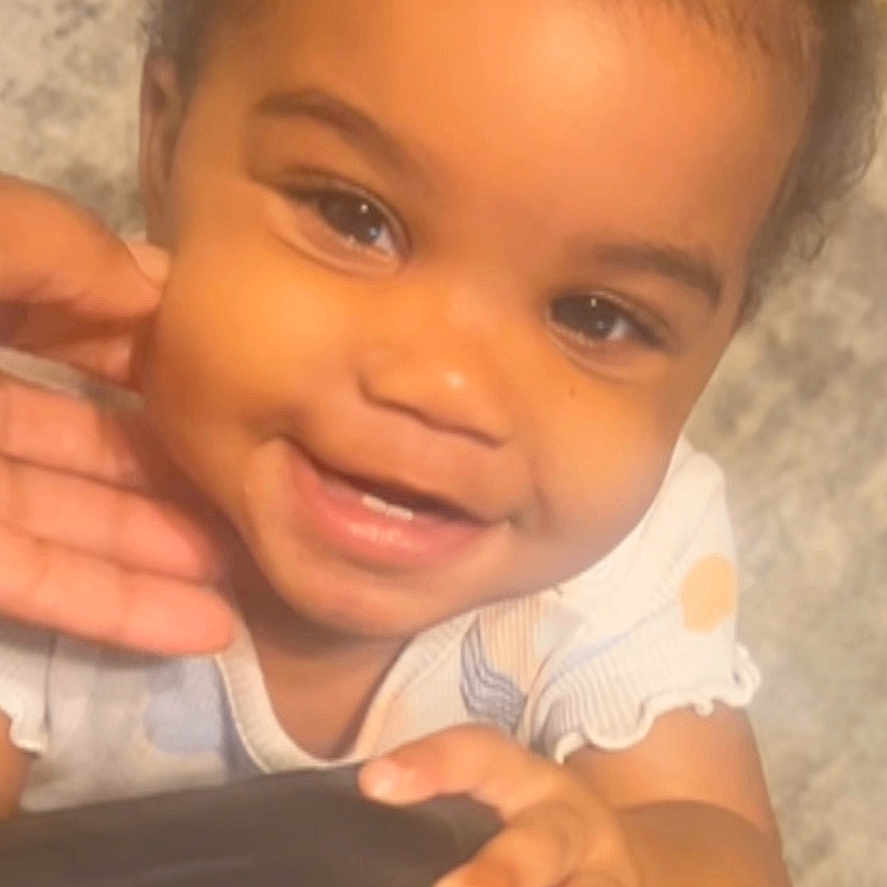 Zoey is registered to the contest to win money with this photo: baby, babylaughing, bodypart, cushion, dimples, face, finger, hand, happy, head, homedecor, laughing, mouth, person, photography, portrait, shoulder, sitting, smile, teeth