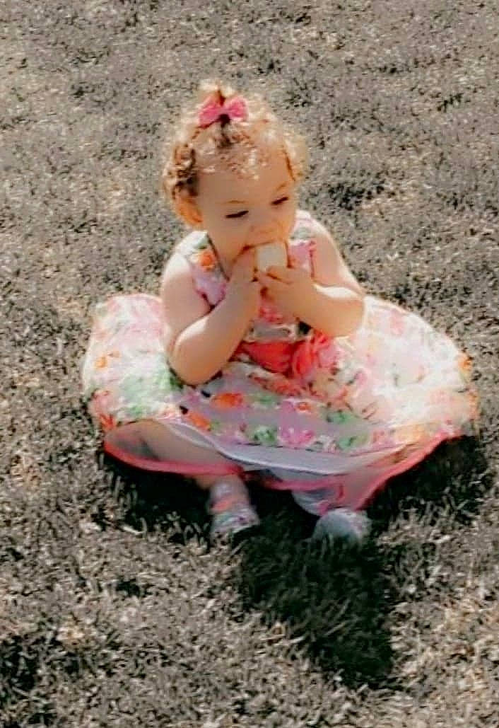 Kora joined the competition — help win amazing prizes! baby, baby_toddler_clothing, blond, child, dress, eye, fawn, foot, fun, grass, head, human_leg, people_in_nature, person, pink, play, recreation, sitting, soil, thigh