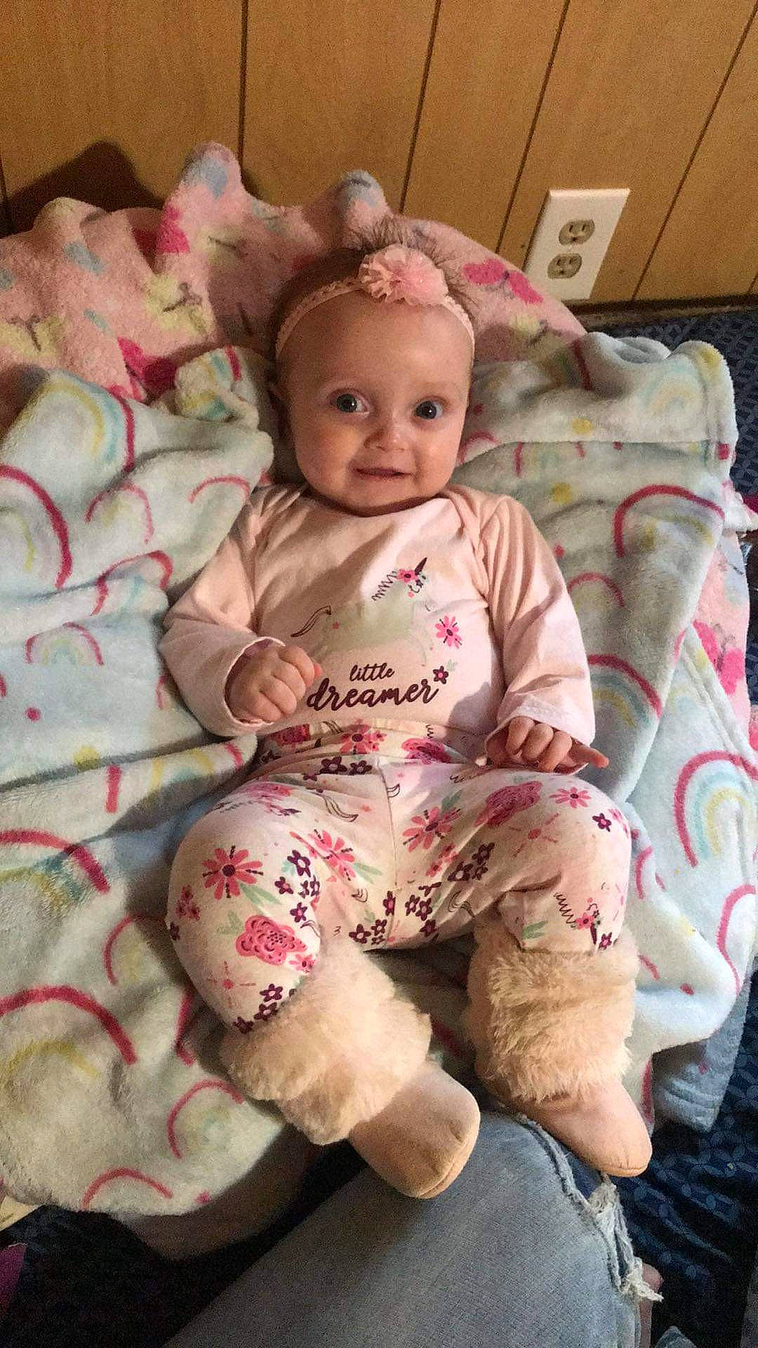 Kinsley is registered to the contest to win money with this photo: baby, baby_products, baby_safety, baby_toddler_clothing, cheek, child, comfort, eye, face, happy, linens, magenta, pattern, person, pink, sitting, skin, sleeve, smile, textile