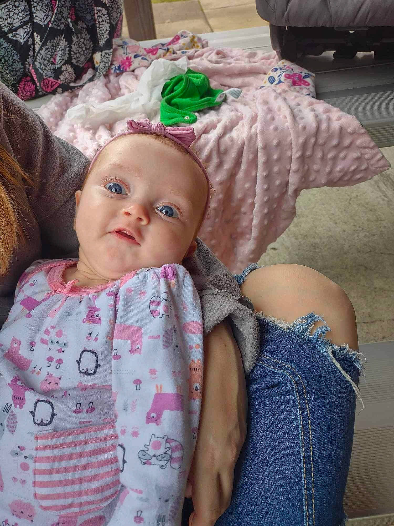Kinsley is registered to the contest to win money with this photo: baby, baby_products, baby_toddler_clothing, cheek, chest, child, comfort, doll, eye, eyelash, fashion_accessory, head, iris, linens, pattern, person, pink, sitting, skin, textile