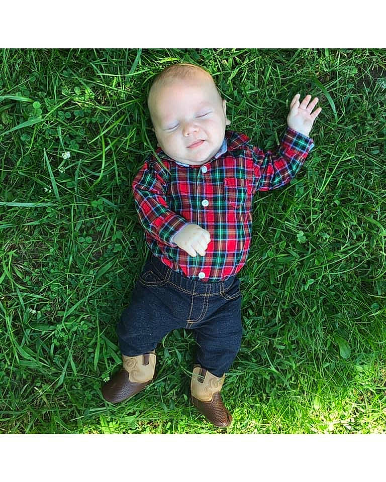 Jarred is registered to the contest to win money with this photo: baby, baby_laughing, baby_toddler_clothing, boot, child, child_model, ear, grass, grass_family, human, mouth, pattern, people_in_nature, person, plaid, shoe, sleeve, sock, tartan, toddler