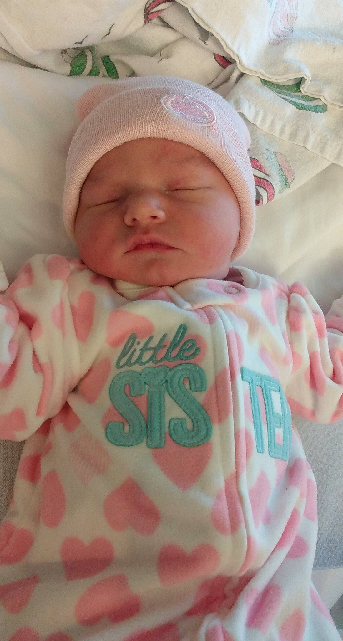 Theodora is registered to the contest to win money with this photo: baby, baby_products, baby_sleeping, baby_toddler_clothing, beanie, bonnet, cheek, child, comfort, headwear, knit_cap, linens, lip, nap, nose, peach, person, pink, skin, sleep