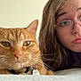 cat, orange_tabby, person, glasses, bed, whiskers, face, pout, fur, collar, indoor, closeup, pet, young_adult, hair, expression, home, relaxing, animal, portrait