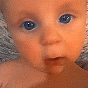 Bentley joined the competition — help win amazing prizes! baby, face, blue_eyes, close_up, infant, skin, expression, blanket, portrait, child, curious, soft_texture, head, young, person, indoor, cute, mouth, nose, eyebrows