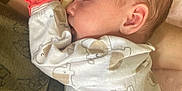 Delaney is registered to the contest to win money with this photo: arm, baby, child, closeup, cozy, cute, elephant_pattern, fabric, indoor, infant, mitten, newborn, onesie, peaceful, person, portrait, rest, skin, sleeping, soft