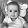 Mia a rejoint le concours — aidez-le/la à gagner de superbes lots ! baby, infant, child, face, eyes, smile, cushion, pillow, seat, clothing, onesie, hand, indoor, portrait, cute, young, black_and_white, expression, person, closeup