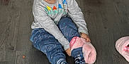 Arlo joined the competition — help win amazing prizes! child, toddler, floor, wooden_floor, slippers, pink_slippers, toy_car, socks, pants, long_sleeve_shirt, happy, smiling, indoor, playful, clothing, person, cute, young_child, playtime, home
