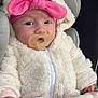 baby, pacifier, headband, pink_bow, blanket, car_seat, jacket, fluffy_clothing, infant, closeup, face, child, cute, warm_clothing, indoor, portrait, young_child, soft_texture, sleepwear, comfort