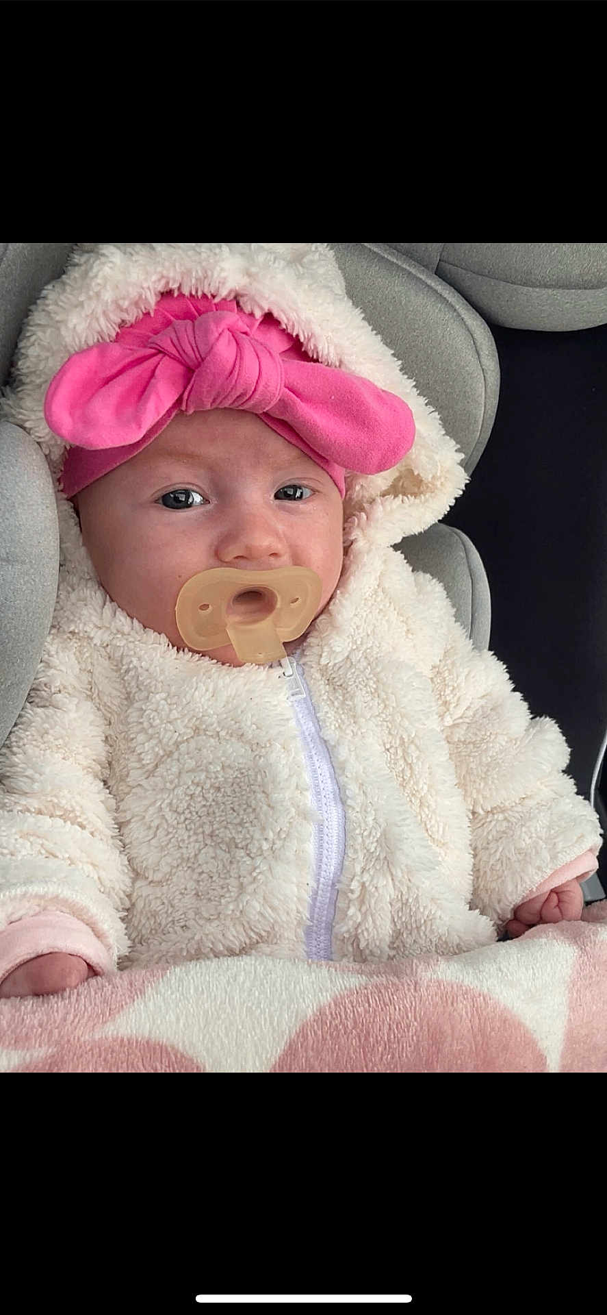 Diana participe au concours pour gagner de l'argent avec cette photo : baby, pacifier, headband, pink_bow, blanket, car_seat, jacket, fluffy_clothing, infant, closeup, face, child, cute, warm_clothing, indoor, portrait, young_child, soft_texture, sleepwear, comfort