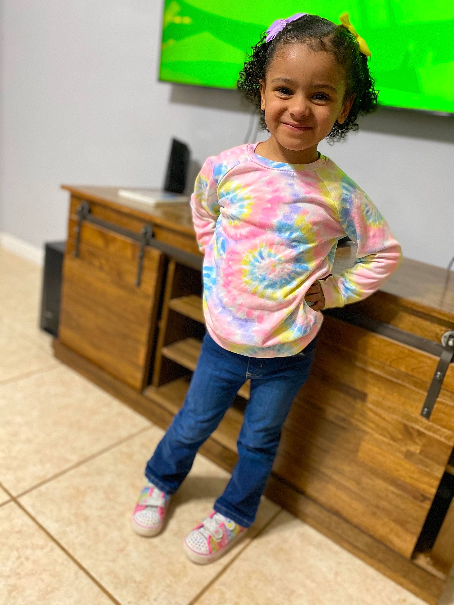 Aubreigh is registered to the contest to win money with this photo: child, face, floor, flooring, fun, green, happy, hardwood, joint, joy, leisure, person, room, skin, smile, standing, t_shirt, toddler, tripod, white