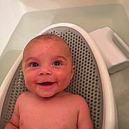 Crue is registered to the contest to win money with this photo: baby, smile, face, child, bathtub, bath, water, skin, infant, happy, relaxing, sitting, cute, young, indoors, person, head, shoulders, seat, plush