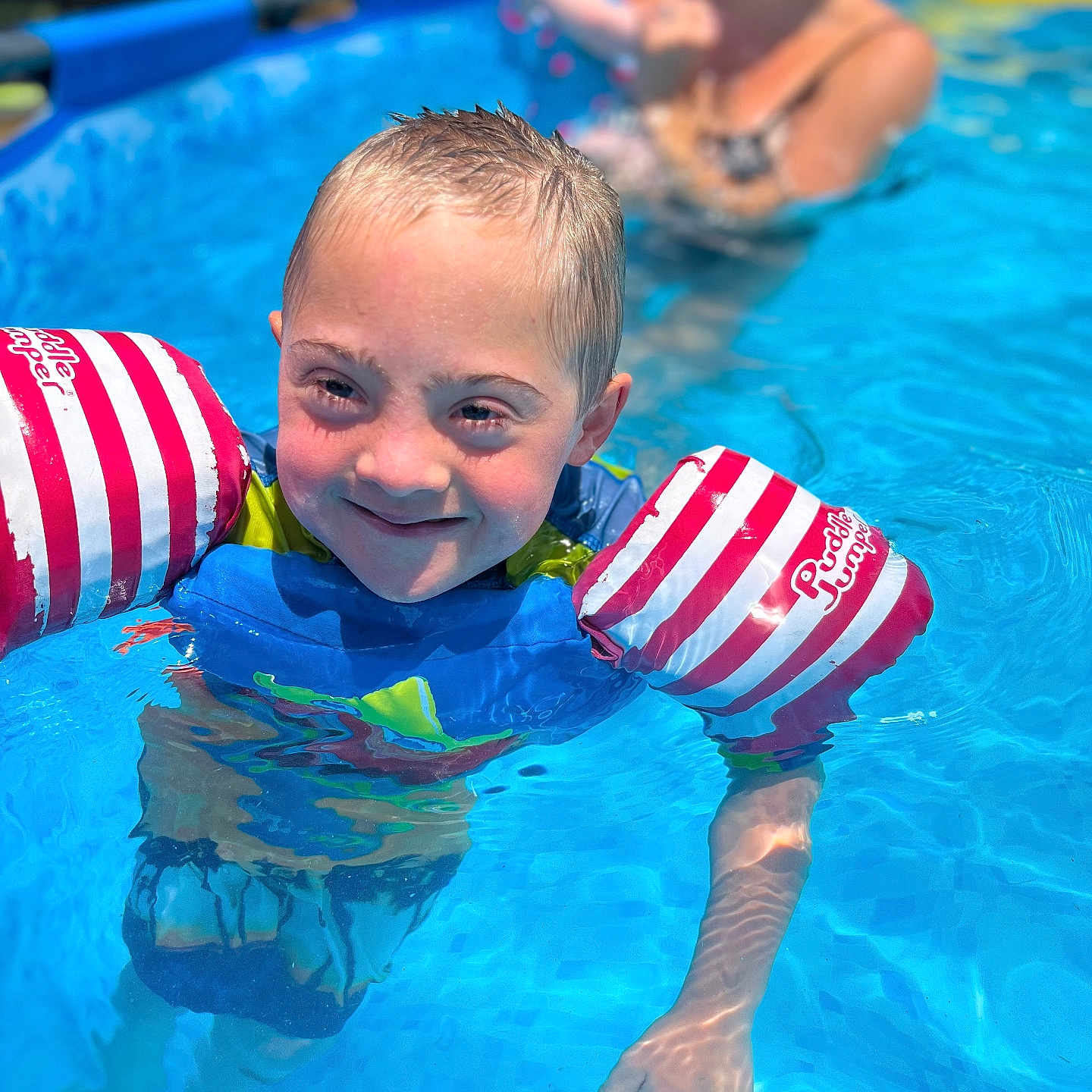 Zayden joined the competition — help win amazing prizes! adult, baby, clothing, face, female, head, leisureactivities, lifejacket, person, photography, pool, portrait, sport, summer, swimming, swimmingpool, vest, water, watersports, woman
