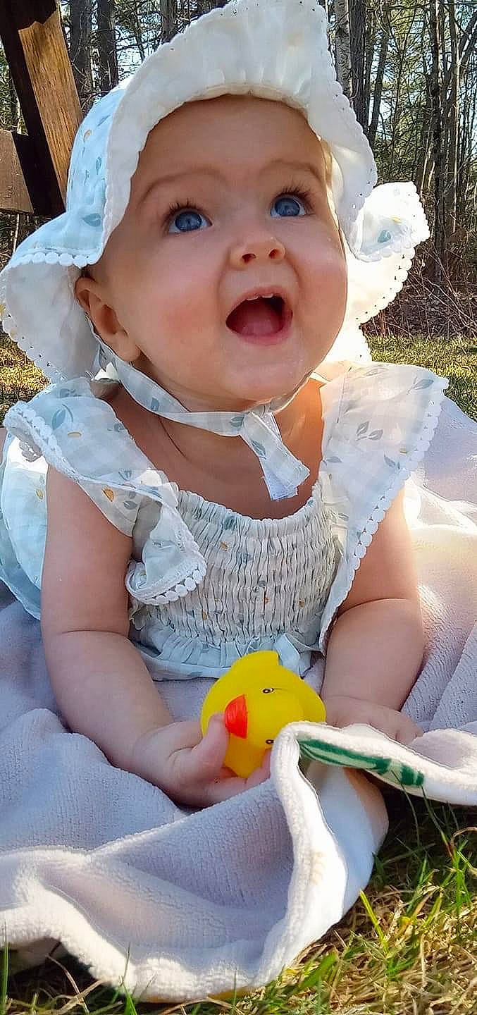 Ariana Elizabeth-rose is registered to the contest to win money with this photo: baby, baby_toddler_clothing, beauty, cheek, child, dress, fun, grass, happy, hat, headwear, person, photograph, pink, plant, sitting, skin, smile, sun_hat, surprise