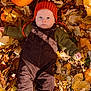 baby, child, autumn, leaves, pumpkin, orange_hat, knitted_hat, overalls, brown_clothing, green_sweater, fall, outdoor, seasonal, cute, portrait, nature, leaf_litter, baby_clothing, fall_colors, season