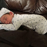 Xavier-James is registered to the contest to win money with this photo: newborn, baby, sleeping, onesie, hat, infant, cozy, cute, resting, soft, peaceful, child, face, clothing, indoor, leather, fabric, pattern, portrait, relaxation