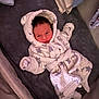 Xavier-James joined the competition — help win amazing prizes! baby, infant, robe, hood, blanket, soft, sleepwear, lying_down, indoor, cute, warm, star_pattern, face, head, person, newborn, cozy, comfort, smile, clothing