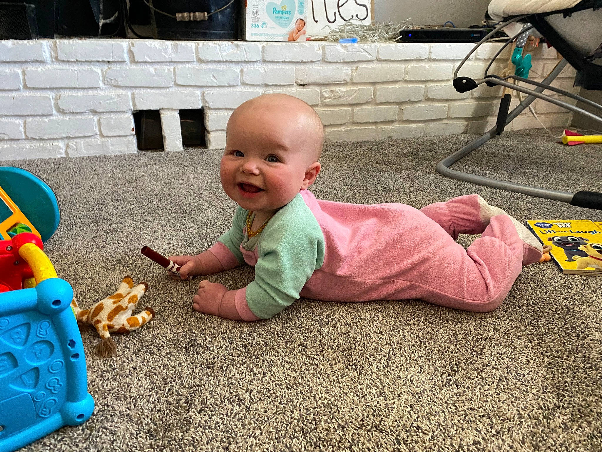 Queeny is registered to the contest to win money with this photo: asphalt, baby, baby_playing_with_toys, baby_products, bicycle_wheel, child, floor, flooring, fun, grass, person, play, recreation, sitting, smile, tire, toddler, toy, toy_block, wheel
