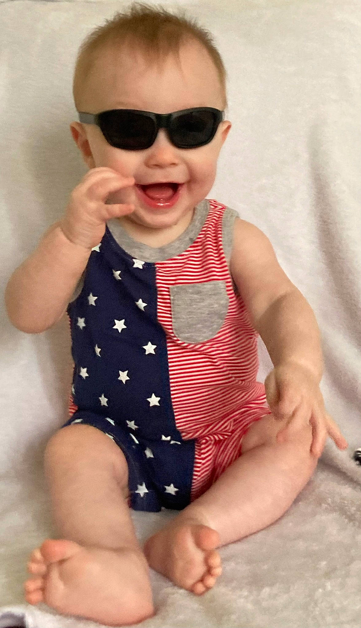 Jamie joined the competition — help win amazing prizes! arm, baby_toddler_clothing, dress, eyewear, face, finger, gesture, glasses, goggles, hand, head, human_body, joint, lip, neck, person, skin, sleeve, smile, sunglasses