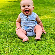 Finnley is registered to the contest to win money with this photo: baby, child, grass, outdoor, smiling, happy, sitting, onesie, drool, infant, greenery, sunlight, cute, portrait, barefoot, young, playful, summer, nature, person