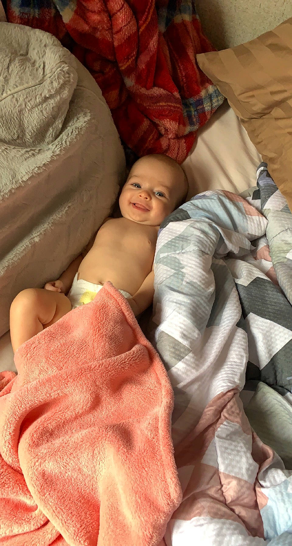 Victoria is registered to the contest to win money with this photo: abdomen, baby, bed, bedding, bedtime, cheek, chest, child, comfort, event, joy, linens, nap, person, pillow, pink, product, room, skin, smile