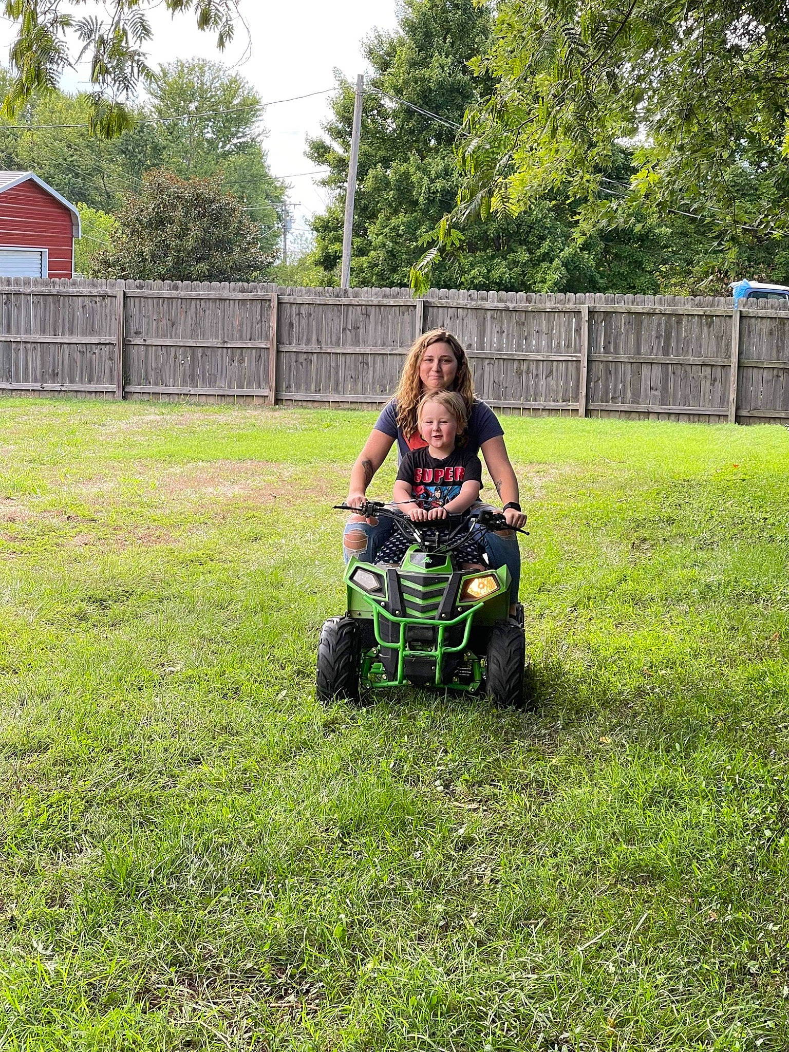 Braxton joined the competition — help win amazing prizes! automotive_wheel_system, fence, grass, grass_family, grassland, joy, landscape, lawn, lawn_mower, meadow, mower, outdoor_power_equipment, people_in_nature, person, plant, recreation, shrub, sky, tire, tree