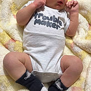 Jasper is registered to the contest to win money with this photo: baby, infant, onesie, socks, blanket, soft_texture, clothing, cute, small_hands, small_feet, lying_down, indoors, newborn, portrait, child, person, sleepwear, cozy, resting, curious