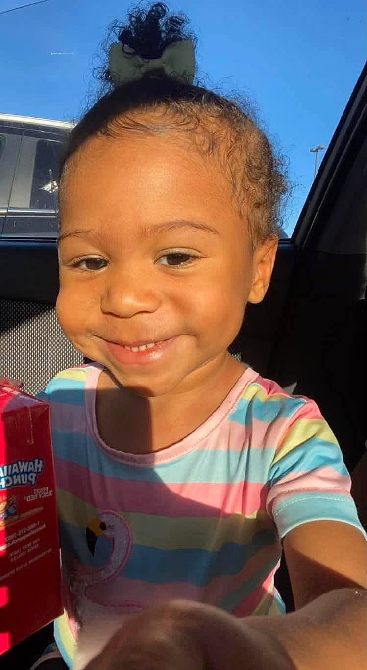 Milani is registered to the contest to win money with this photo: cheek, chin, cloud, cool, eyebrow, eyelash, forehead, happy, iris, joy, lip, mouth, nose, person, skin, sky, smile, standing, t_shirt, toddler