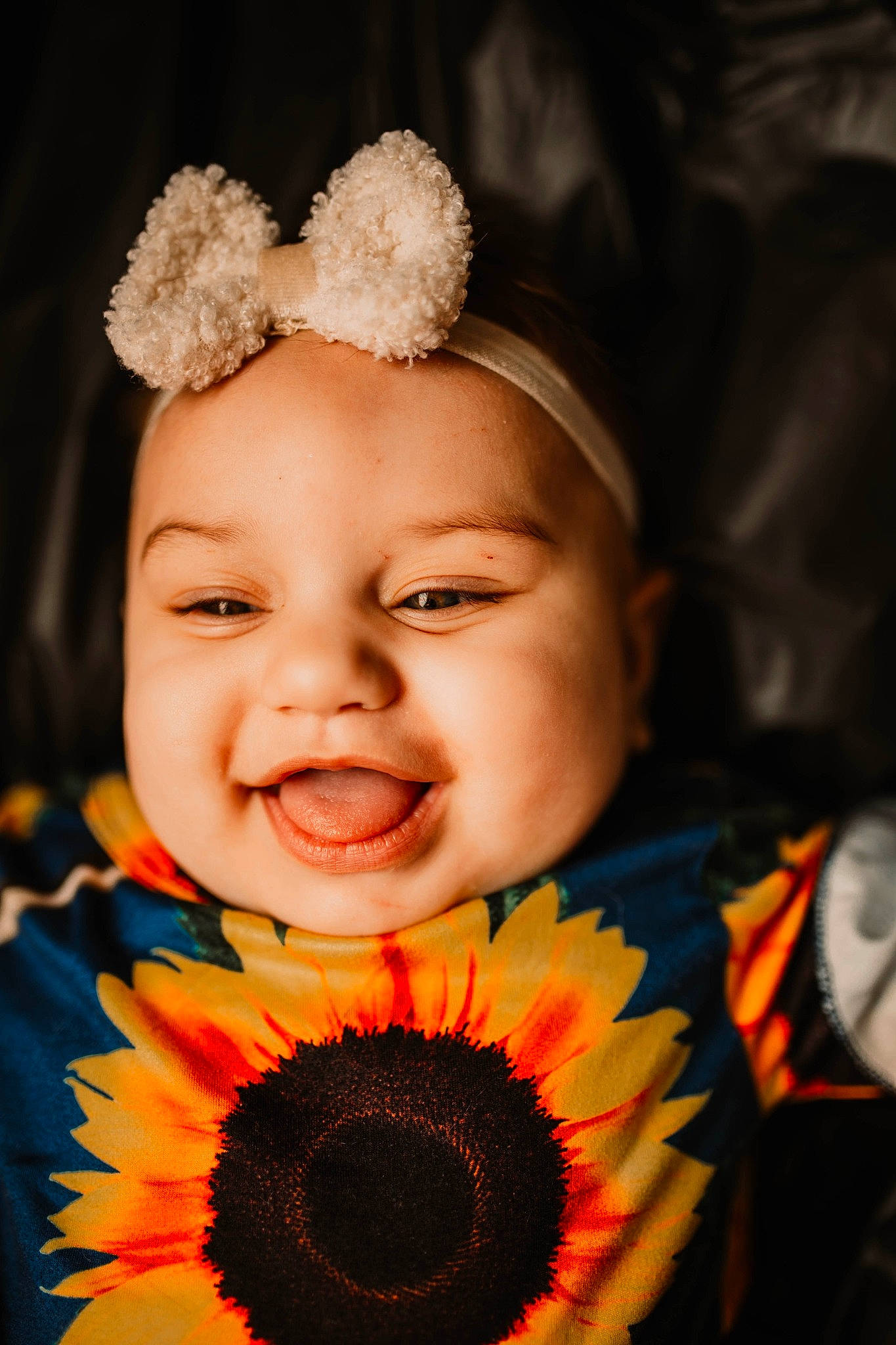 Melanie Jaye is registered to the contest to win money with this photo: baby, dress, eye, face, facial_expression, flash_photography, flower, hairstyle, happy, head, headgear, headwear, human_body, iris, lip, mouth, organ, person, petal, plant