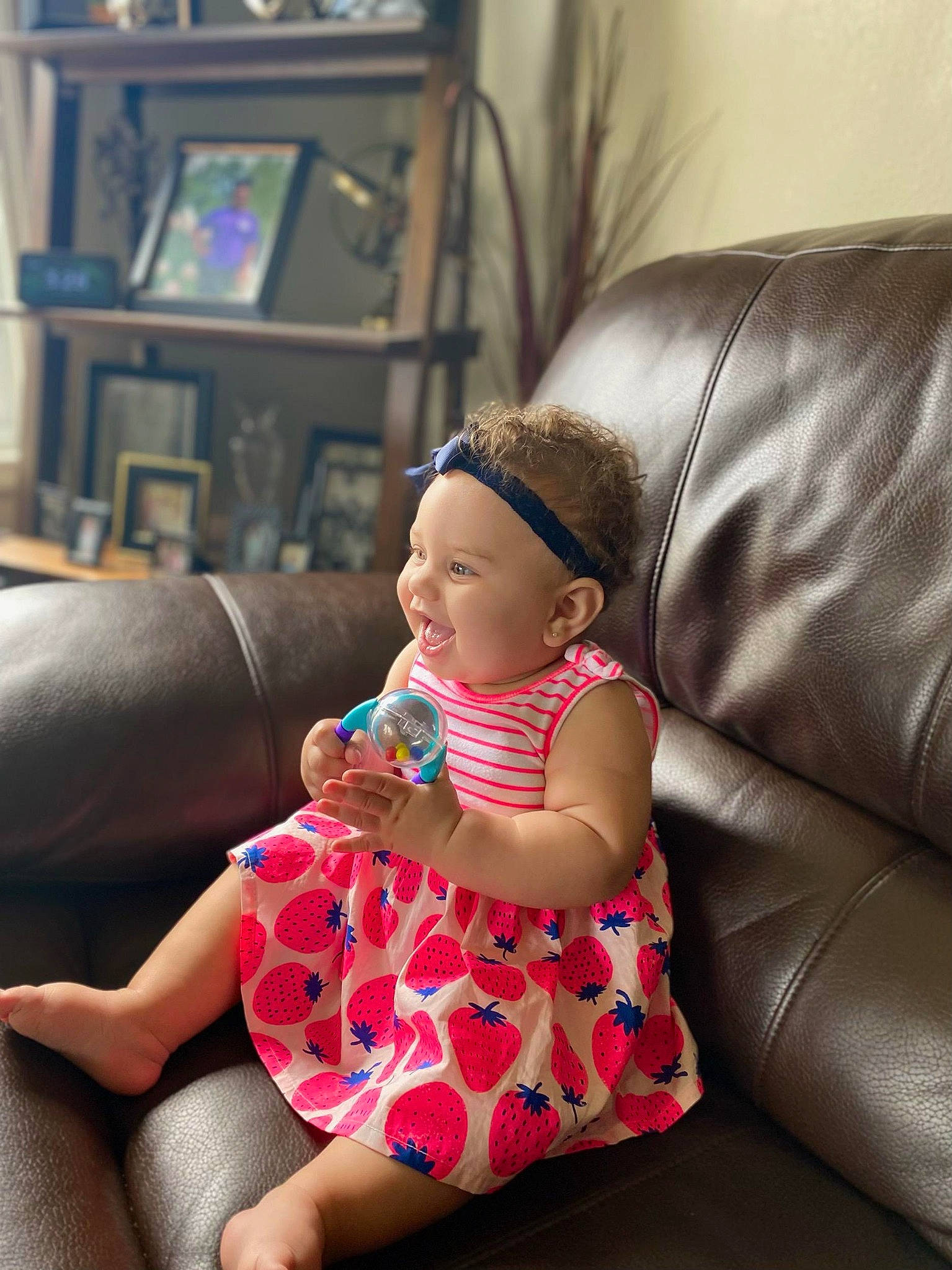 Melanie Jaye joined the competition — help win amazing prizes! baby, baby_toddler_clothing, bookcase, comfort, couch, foot, fun, headwear, human_leg, knee, lap, living_room, magenta, person, picture_frame, purple, room, shelf, sitting, sock