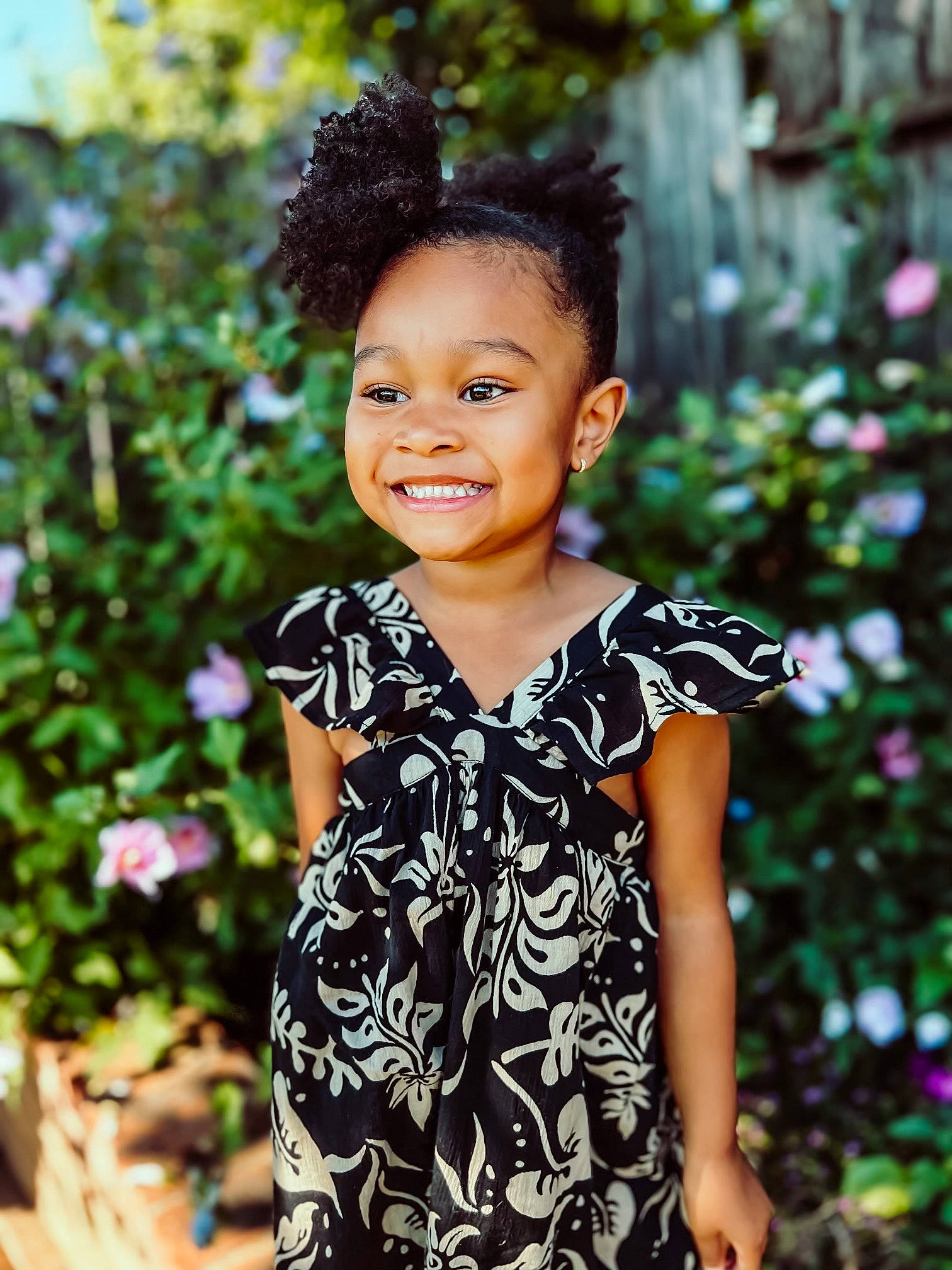 Amani is registered to the contest to win money with this photo: baby_toddler_clothing, beauty, botany, child, day_dress, dress, flash_photography, formal_wear, grass, happy, head, iris, joy, magenta, pattern, people_in_nature, person, plant, sleeve, smile