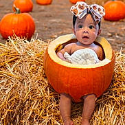 Willow is registered to the contest to win money with this photo: baby, pumpkin, hay, autumn, outdoor, child, bow, orange, cute, festival, fall, nature, smiling, seasonal, portrait, holiday, harvest, ground, decoration, fun