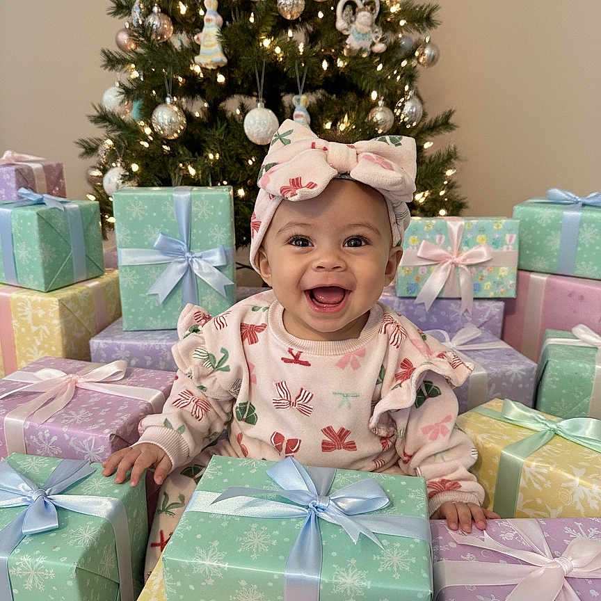 Willow joined the competition — help win amazing prizes! baby, bow, celebration, child, christmas_tree, cute, decorations, festive, gift_boxes, happy, headband, holiday, holiday_lighting, indoors, joyful, presents, ribbon, sitting, smiling, winter