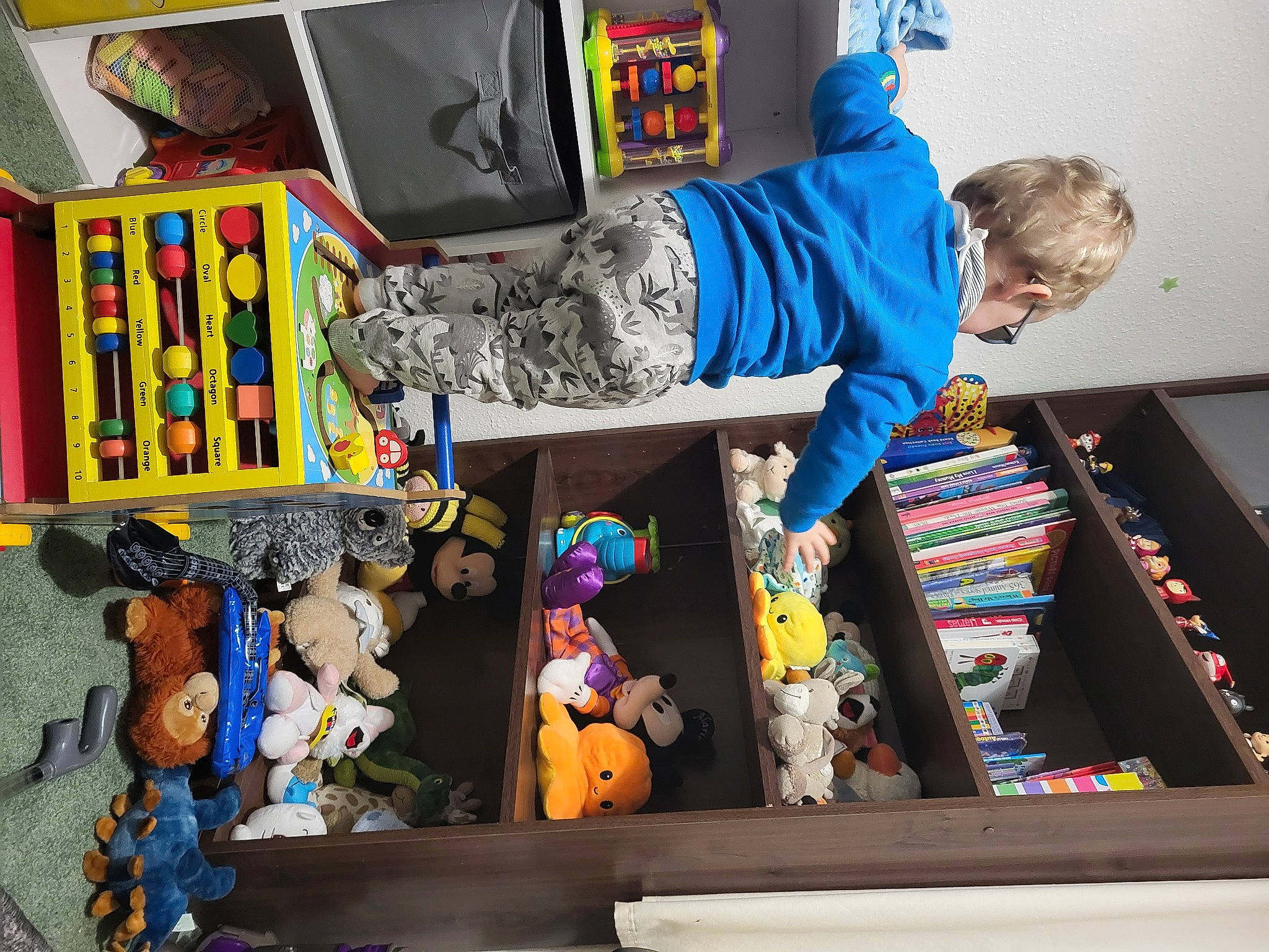 Alaric is registered to the contest to win money with this photo: animation, art, bag, bookcase, chair, collection, fictional_character, fun, guitar, hat, luggage_and_bags, person, plastic, play, publication, room, shelf, shelving, stuffed_toy, toy
