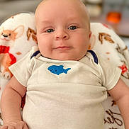 Clayton joined the competition — help win amazing prizes! baby, infant, onesie, blue_fish, blanket, dog_pattern, cute, child, portrait, skin, hand, smile, face, lying_down, indoor, soft, warm, cozy, young, expression