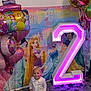 toddler, child, birthday, balloons, princess, backdrop, number_two, glowing, pink, white_clothing, carpet, phone, smiling, indoor, celebration, decorations, party, happy, young_child, festive