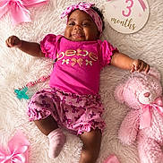 Kahleesi is registered to the contest to win money with this photo: baby, infant, pink_clothing, headband, smiling, lying_down, plush_toy, teddy_bear, pacifier, blanket, bows, celebration, milestone, cute, child, happy, indoors, portrait, soft_texture, three_months