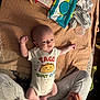 baby, infant, onesie, taco_graphic, blanket, baby_wipes, pacifier, clothing, person, legs, hands, fabric, home, texture, cute, lying_down, infant_clothing, baby_accessories, relaxing, cozy