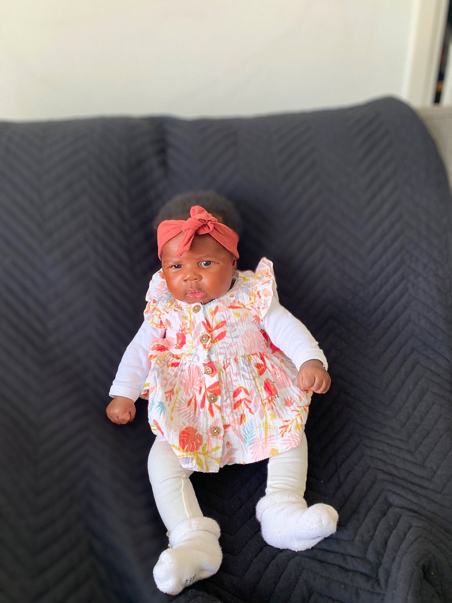 Assiya participe au concours pour gagner de l'argent avec cette photo : baby, baby_toddler_clothing, carmine, cheek, child, comfort, couch, eye, face, hat, headwear, linens, pattern, peach, person, pillow, room, sitting, sleeve, throw_pillow