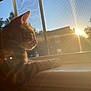 cat, window, sunlight, sunset, orange_cat, pets, indoor, animal, feline, resting, windowsill, screen, nature_outside, house, sunbeam, warm_light, daylight, calm, relaxation, silhouette