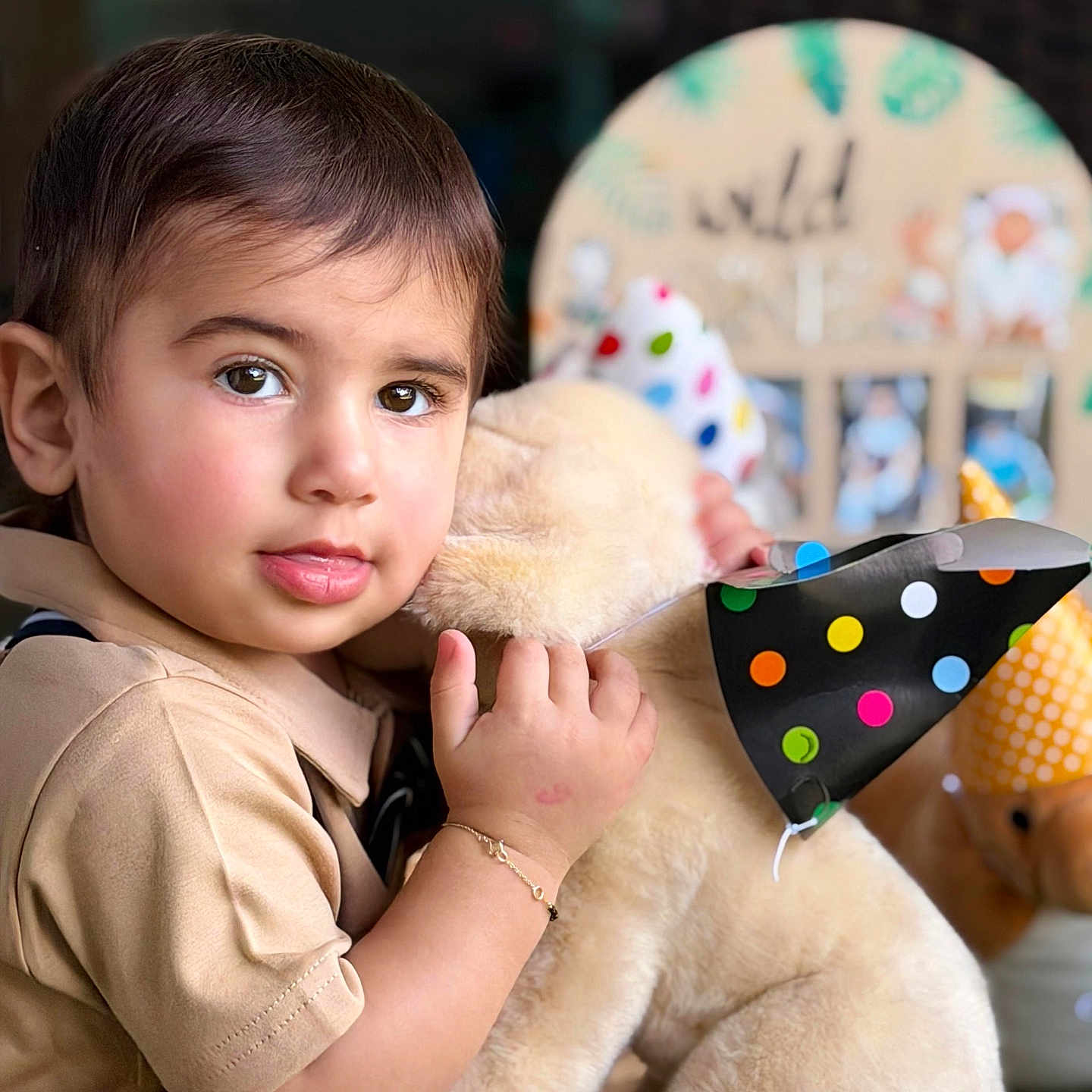 Neo is registered to the contest to win money with this photo: toddler, child, face, plush_toy, teddy_bear, party_hat, polka_dot, cuddling, portrait, indoors, soft_lighting, short_hair, brown_hair, skin, clothing, bracelet, happy, cute, celebration, background_blur