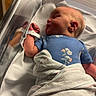Evelyn is registered to the contest to win money with this photo: newborn, baby, hospital, bassinet, blanket, blue_onesie, sleeping, infant, wristband, medical, child, portrait, indoor, bed, cute, peaceful, small, human, resting, delicate