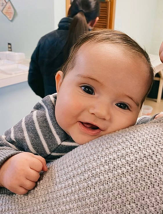 Noel is registered to the contest to win money with this photo: baby, cheek, chin, comfort, ear, eyebrow, eyelash, facial_expression, finger, floor, gesture, happy, iris, lip, mouth, neck, nose, person, skin, sleeve