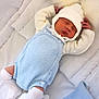 newborn, baby, sleeping, blue_clothing, white_clothing, knitted, hat, pom_poms, soft_bedding, blanket, cozy, infant, cute, peaceful, resting, indoors, portrait, child, small, warm