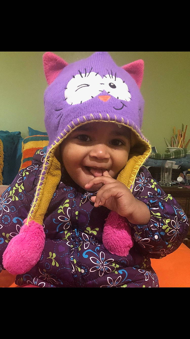 Ashanti is registered to the contest to win money with this photo: beanie, bonnet, cap, child, fashion_accessory, hat, headgear, headwear, joy, knit_cap, magenta, person, pink, purple, smile, toddler