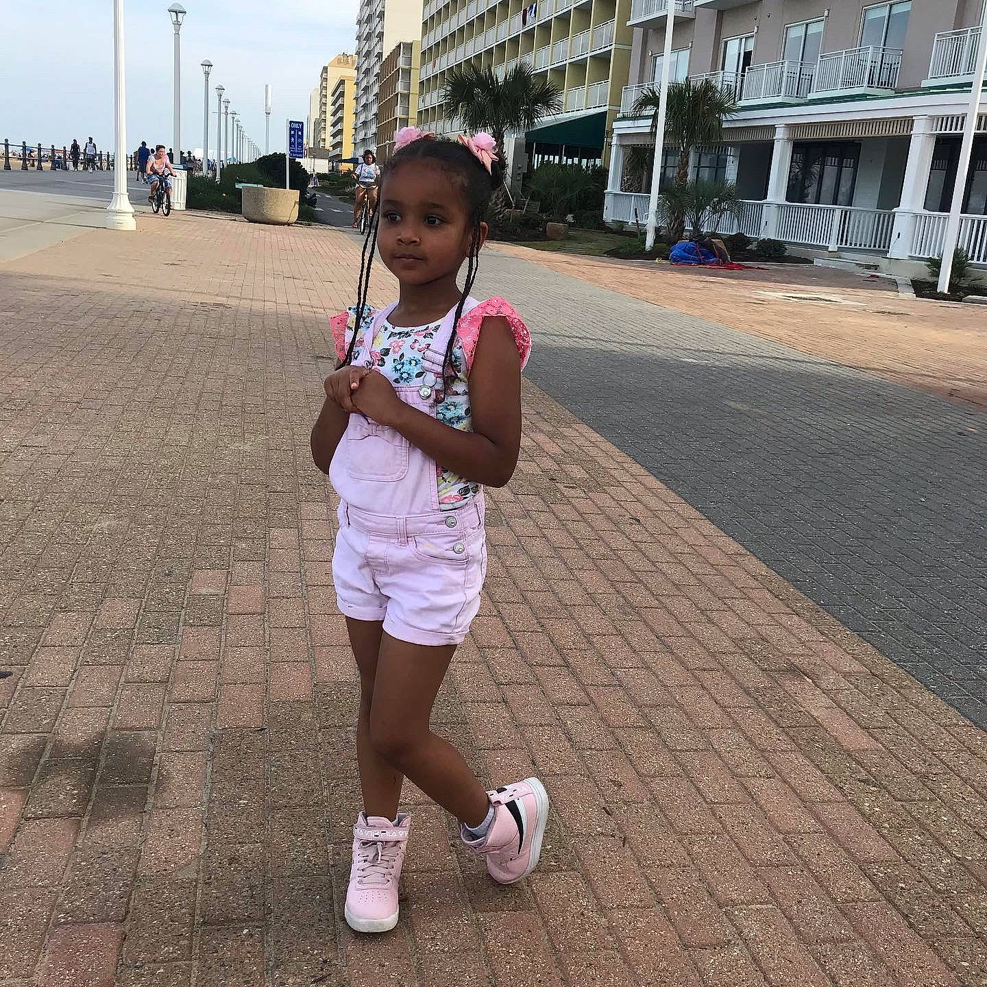 Herani is registered to the contest to win money with this photo: city, eyewear, flooring, fun, happy, human_leg, leg, leisure, pedestrian, person, recreation, road, shorts, sky, sock, summer, t_shirt, thigh, toddler, travel