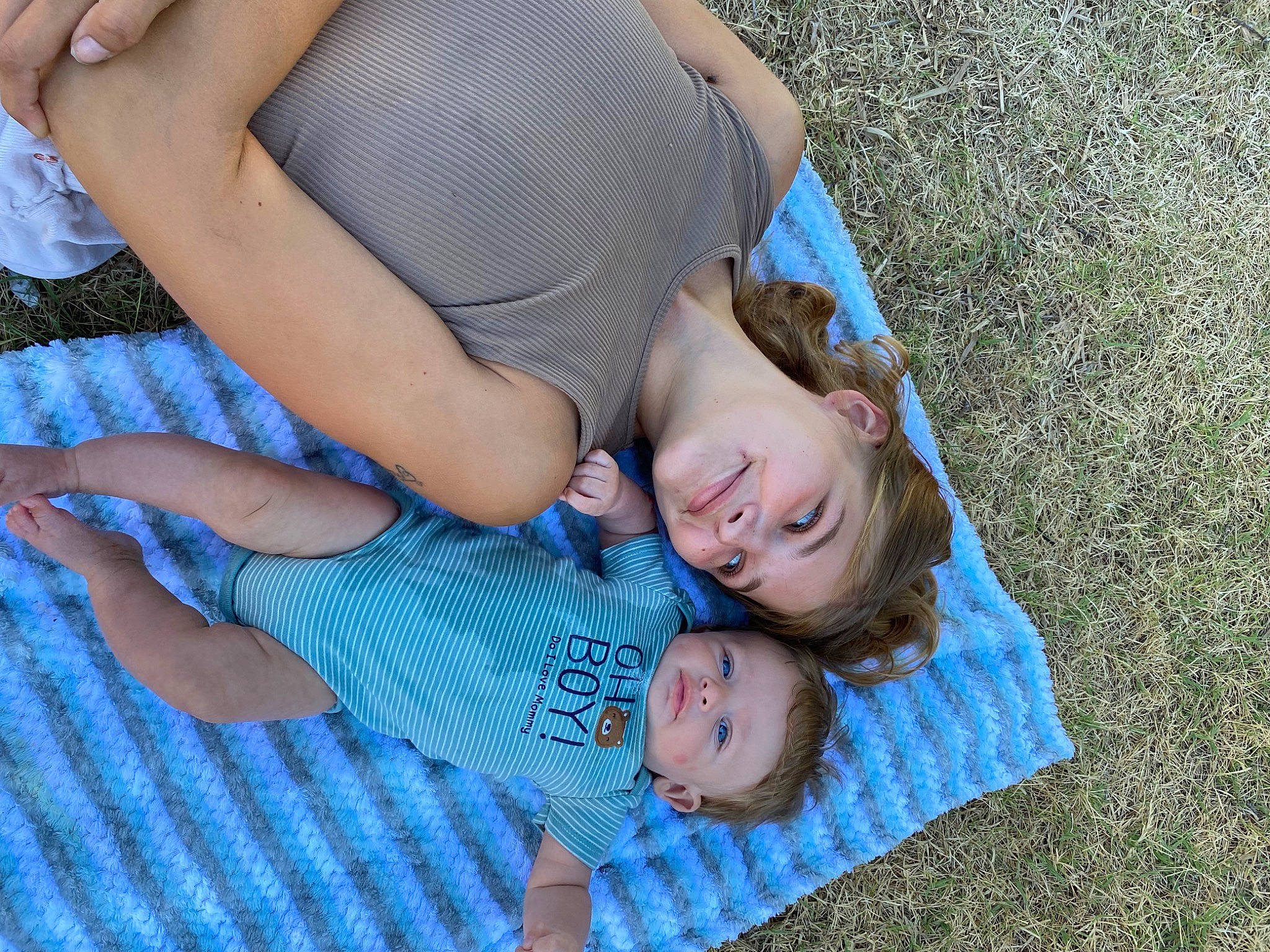 Tracey is registered to the contest to win money with this photo: baby, baby_toddler_clothing, child, electric_blue, flooring, fun, grass, grassland, happy, human_leg, joy, leisure, pattern, people_in_nature, person, sitting, thigh, toddler, tree, vacation